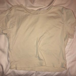 Light/pastel yellowish cream colored crop top